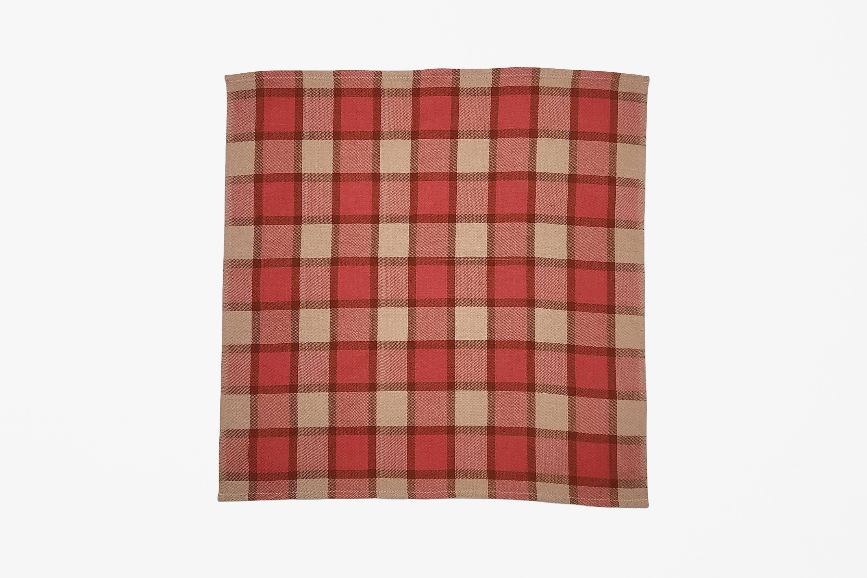 A square woven plaid napkin with a red, pink, and beige plaid pattern, displayed flat against a solid white background.