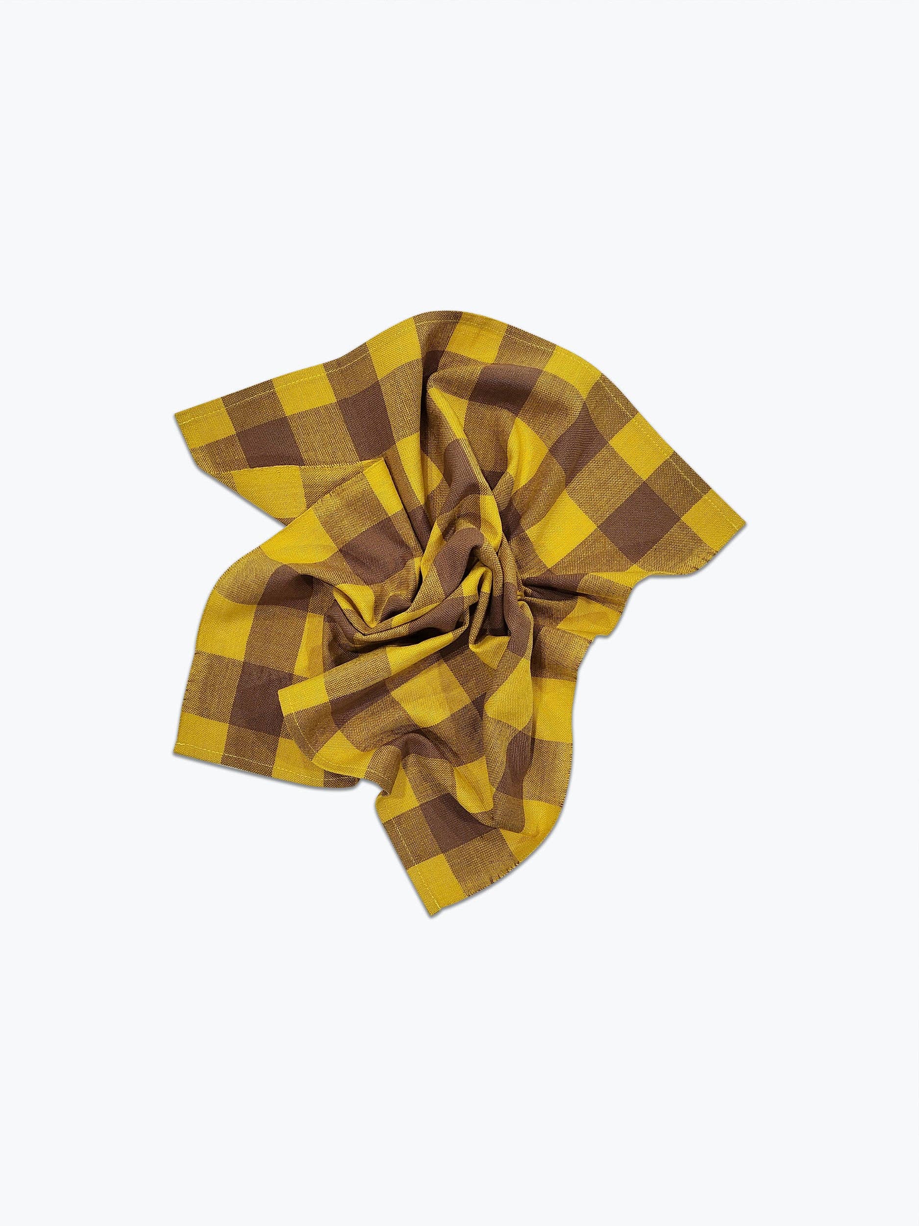 A handwoven yellow and brown gingham napkin displayed on a white background.