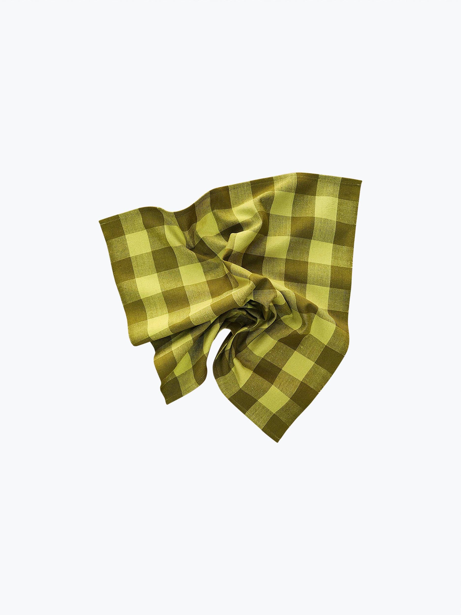 A handwoven green and yellow checkered cotton napkin on a white background.
