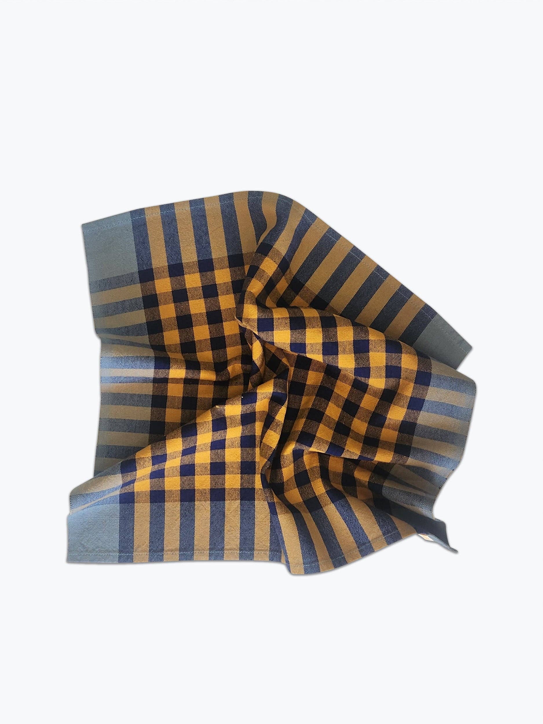 A handwoven plaid napkin with blue and yellow pattern on a white background.