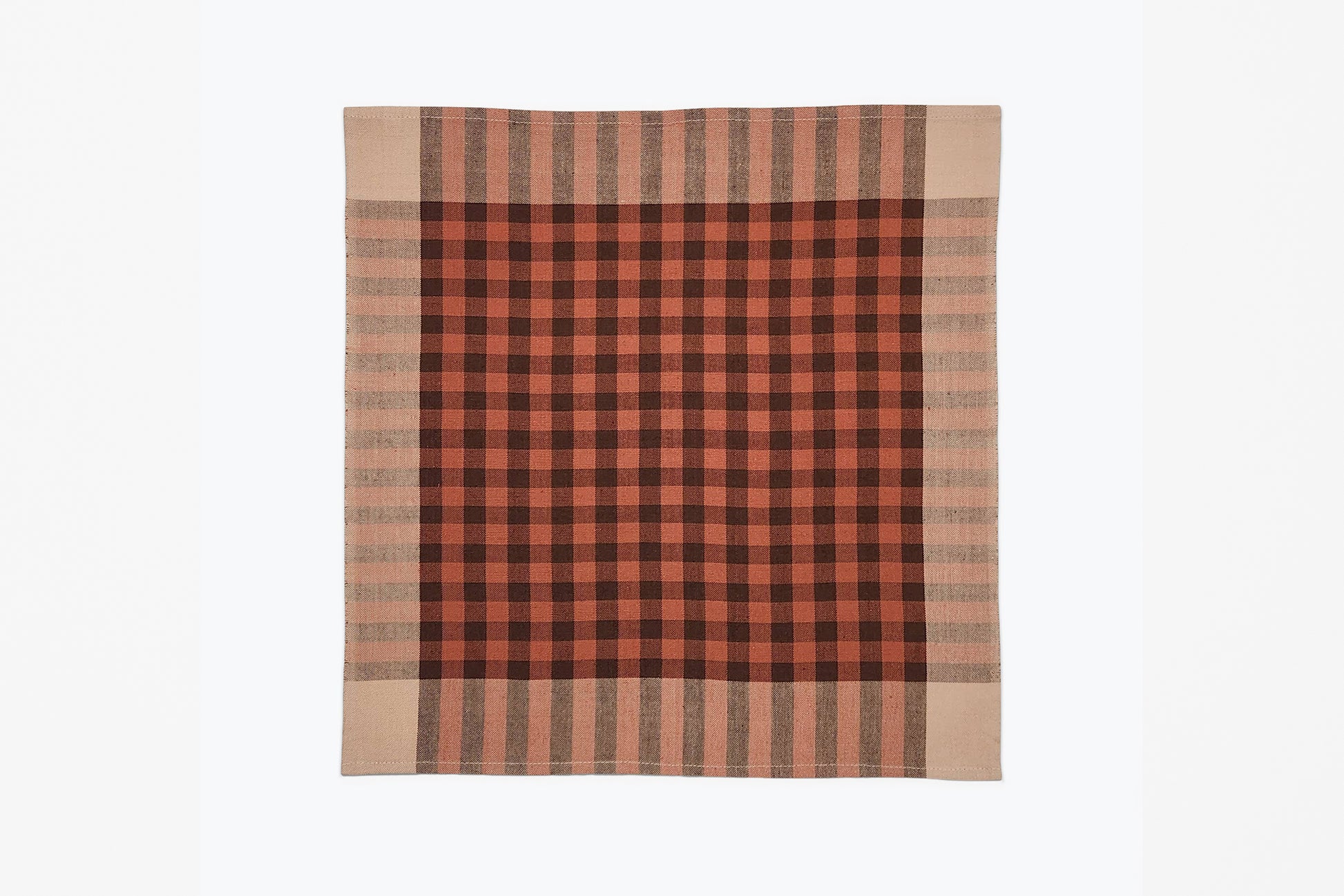 A square woven plaid napkin with a red, brown, and beige detail, displayed flat against a plain white background.