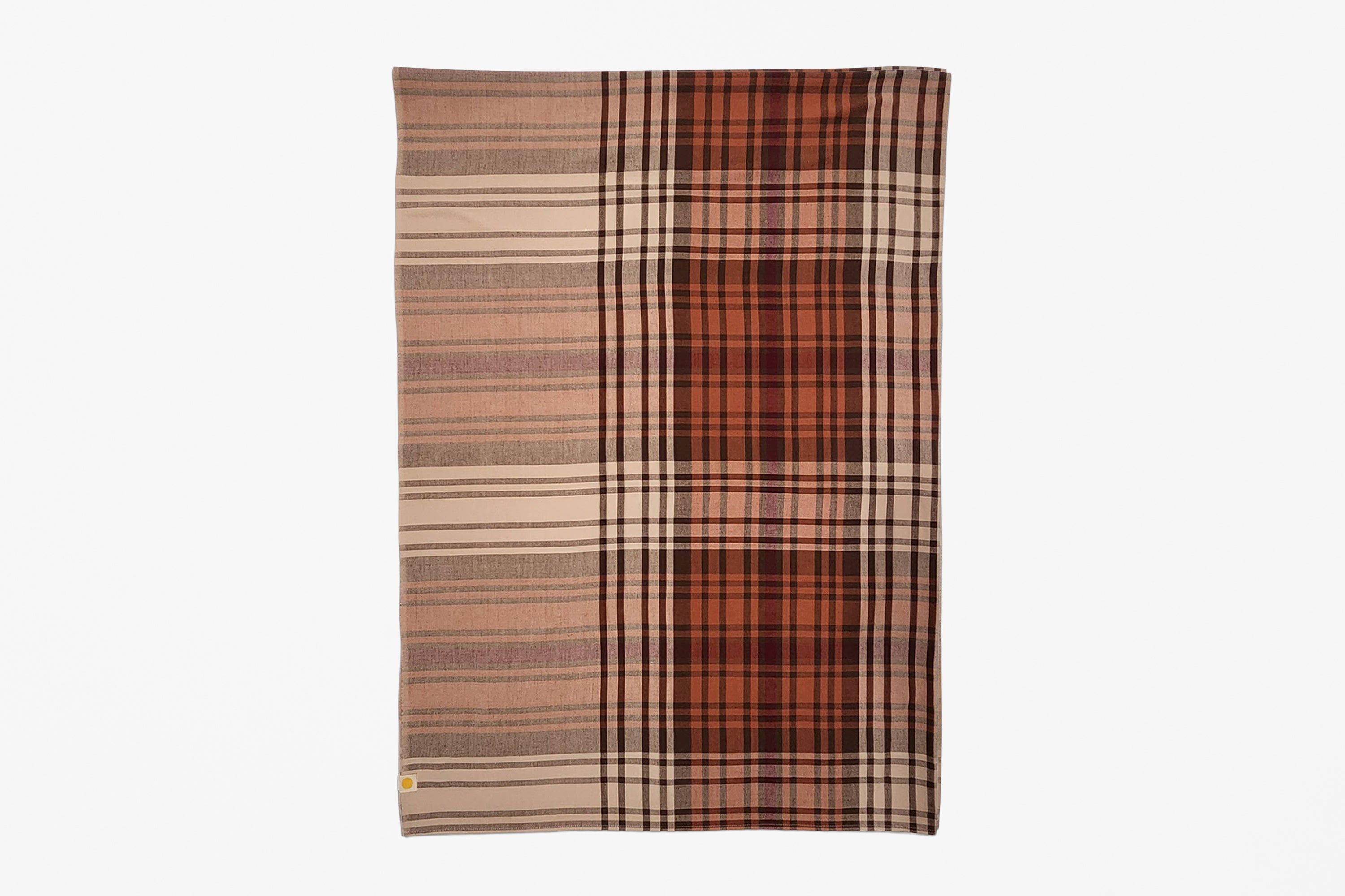 A rectangular woven textile with a plaid pattern, featuring vertical sections of beige and brown stripes on the left and a rust-orange and dark brown plaid on the right, shown flat against a light gray background.