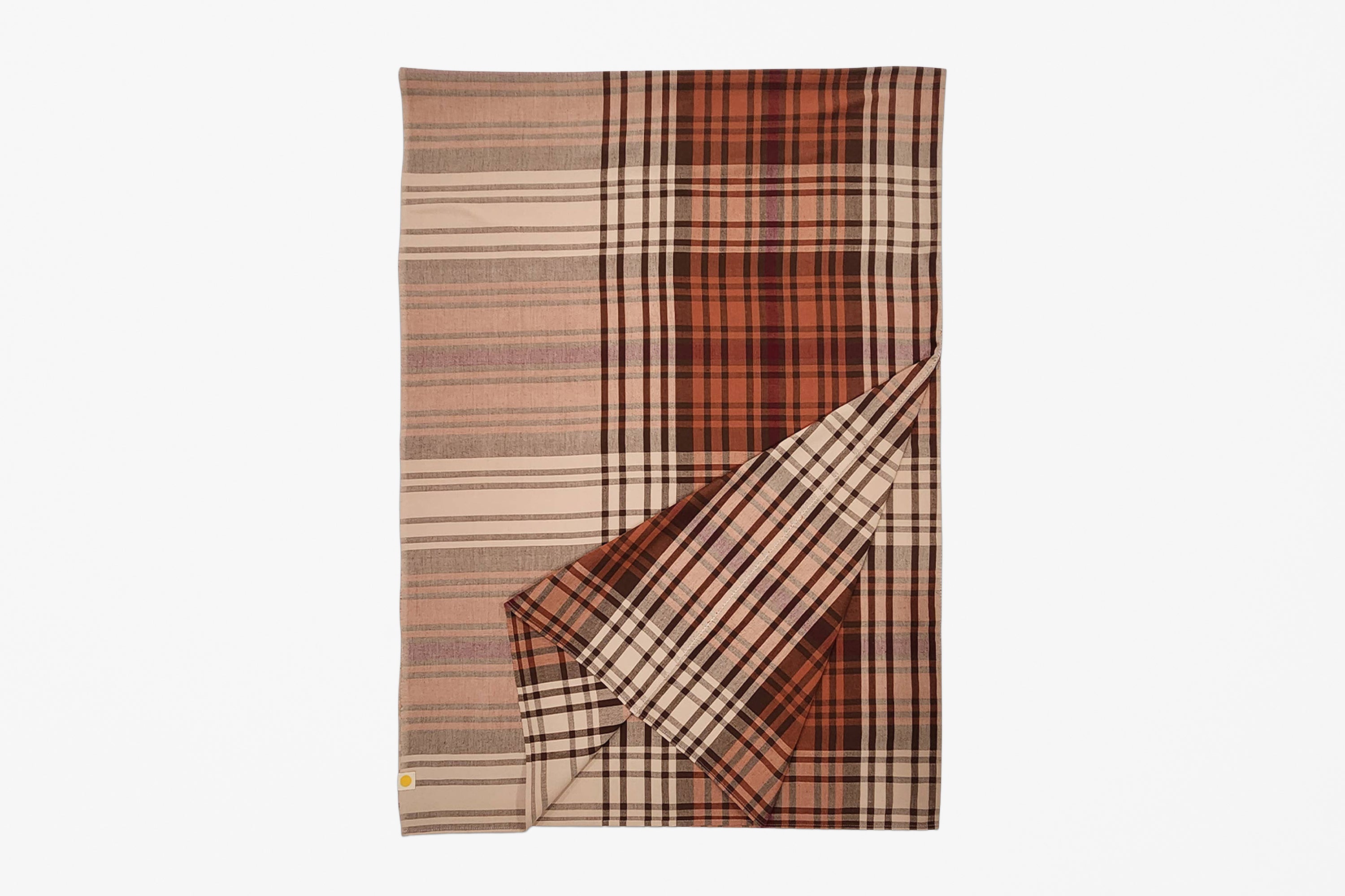 A folded plaid blanket or throw in warm autumn tones, featuring stripes of rust orange, brown, beige, and black, shown against a plain white background.