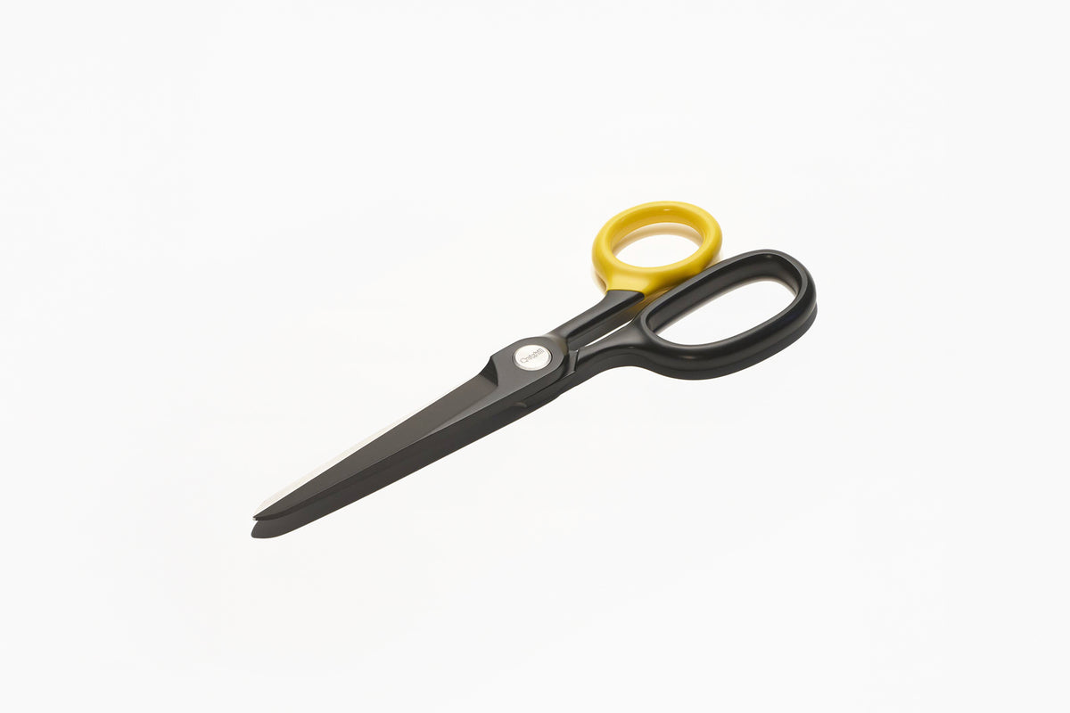 Black scissors with yellow handles on a white background