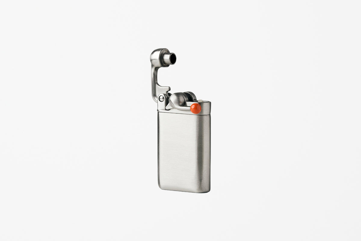 A silver metallic pocket lighter with a built-in camera lens on the hinged lid, shown against a plain white background.