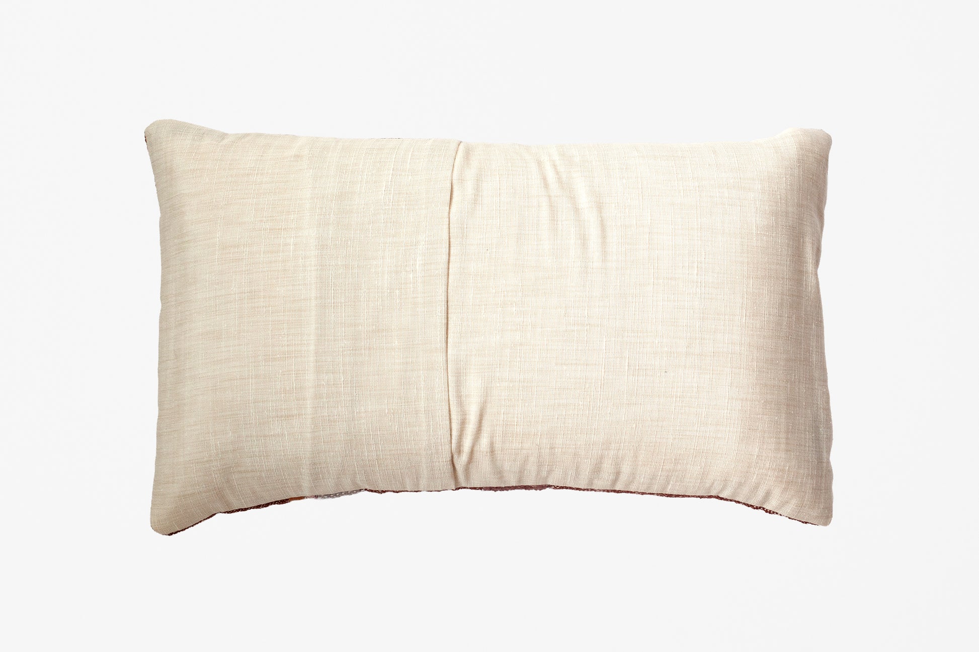 A rectangular lumbar pillow in a light beige linen fabric, featuring a central vertical seam, shown against a plain white background.