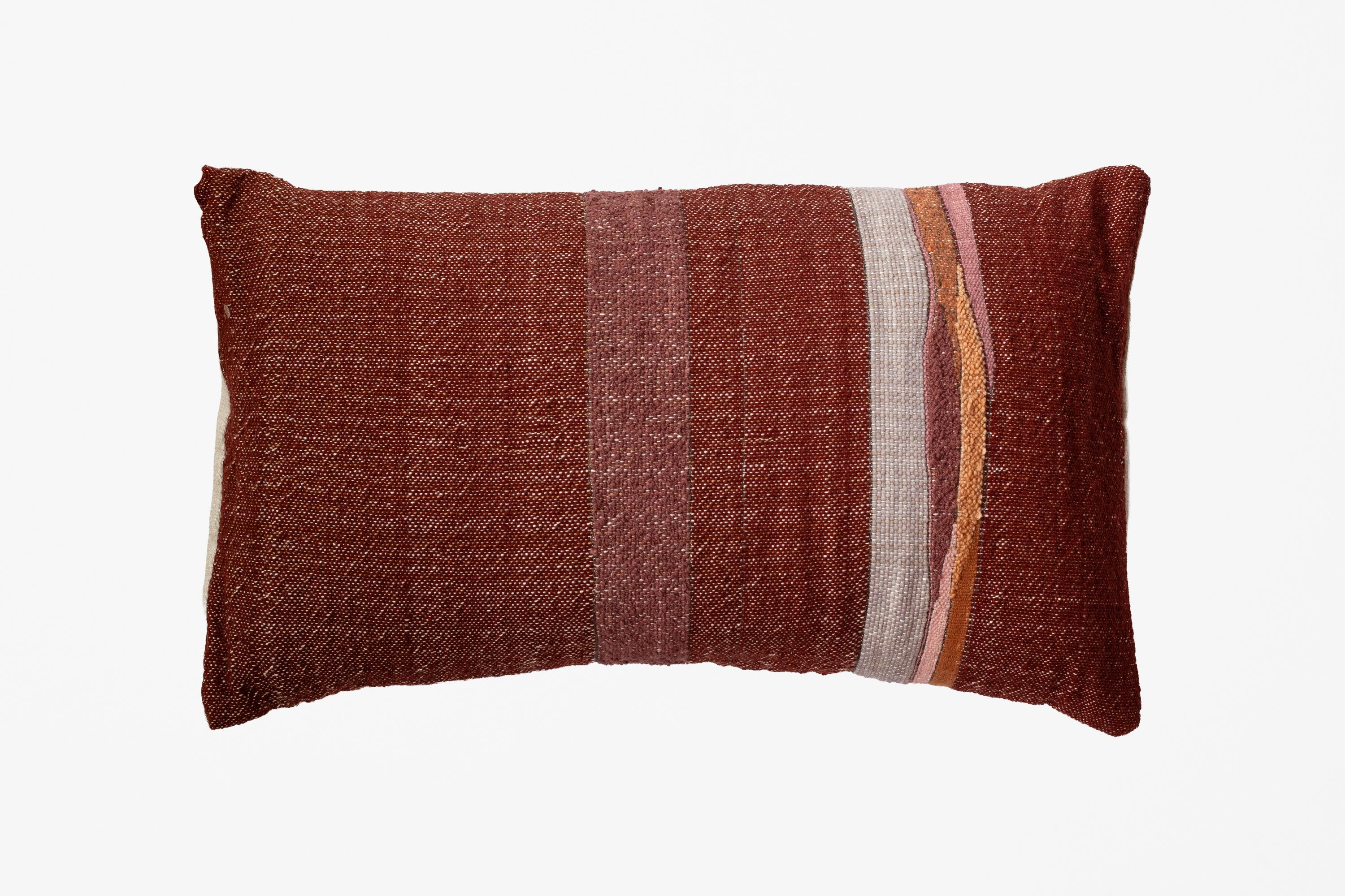 A rectangular woven throw pillow in a textured rust-brown color, featuring vertical stripes of beige, pink, and orange on the right side, set against a plain white background.