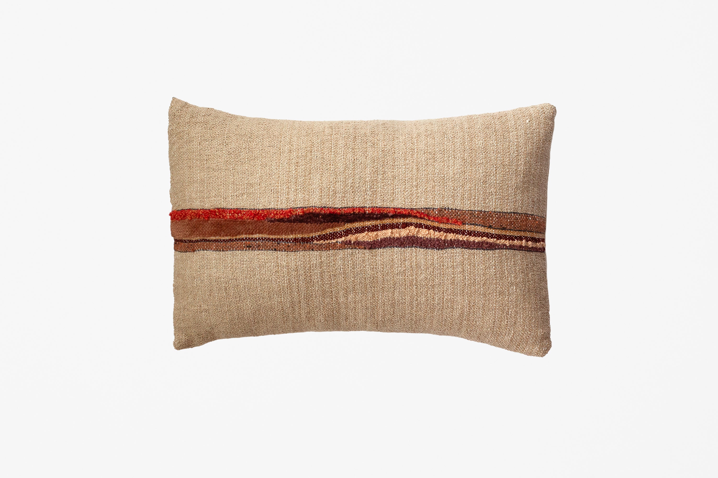 A rectangular beige textured throw pillow with a horizontal band of rust red, orange, and brown stripes across the center, shown on a plain white background.