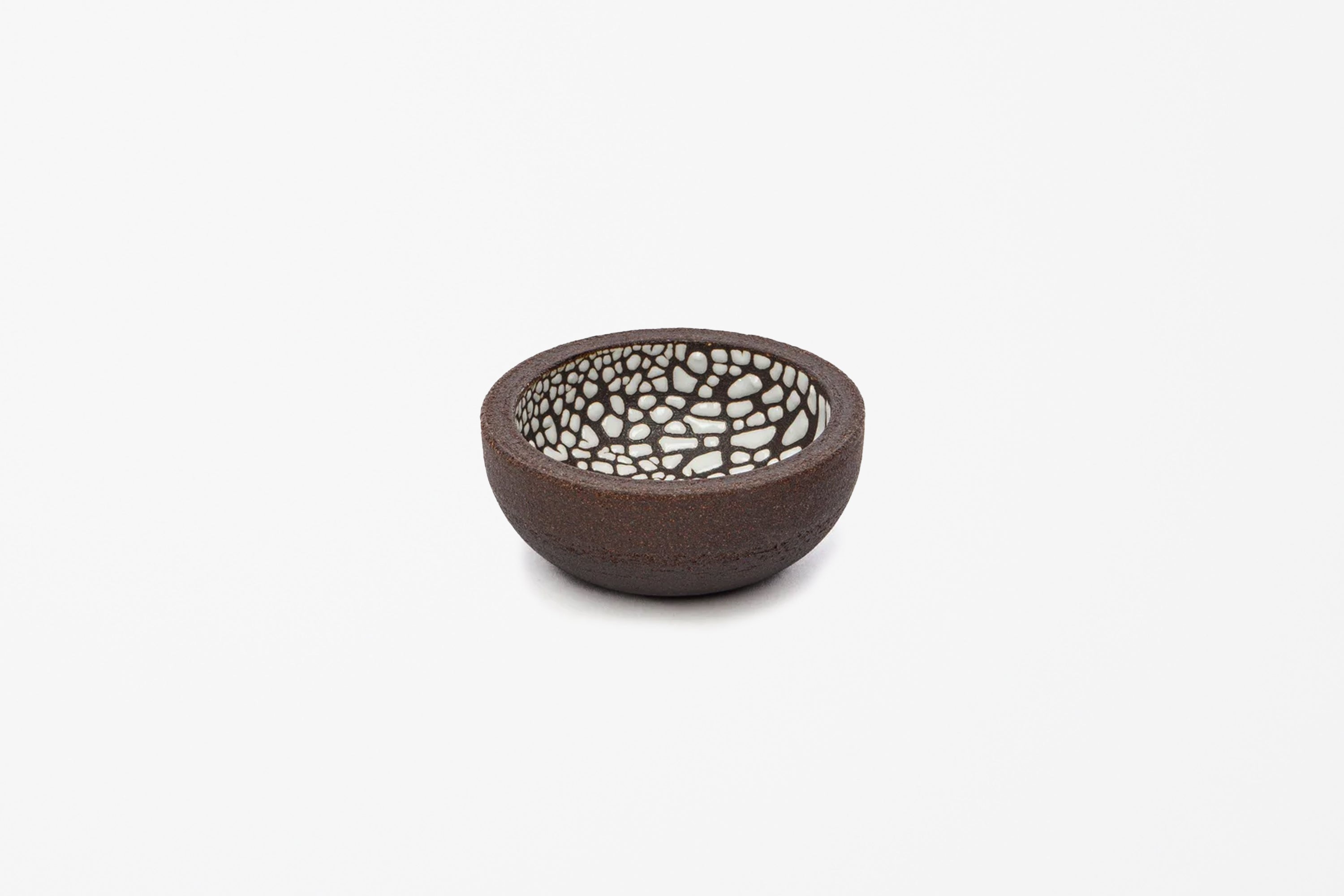 A small handmade ceramic bowl with a dark brown textured exterior and a white crackle glazed interior, shown on a plain white background.