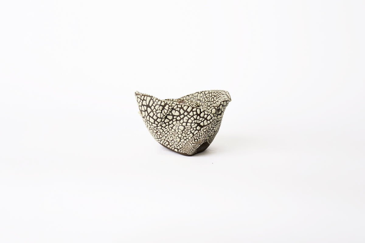 A large hand-built brown stoneware planter with dotted white textured glaze surface on a white background.
