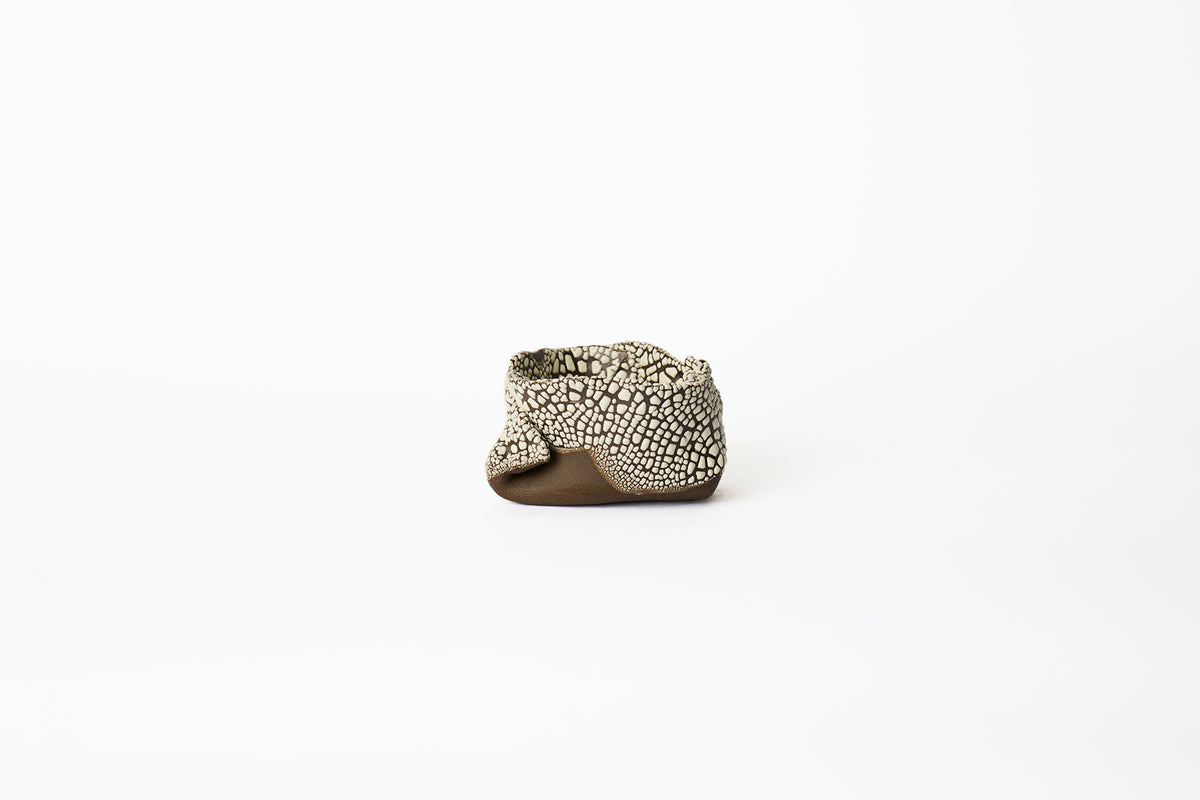 A medium hand-built brown stoneware planter with dotted white textured glaze surface on a white background.