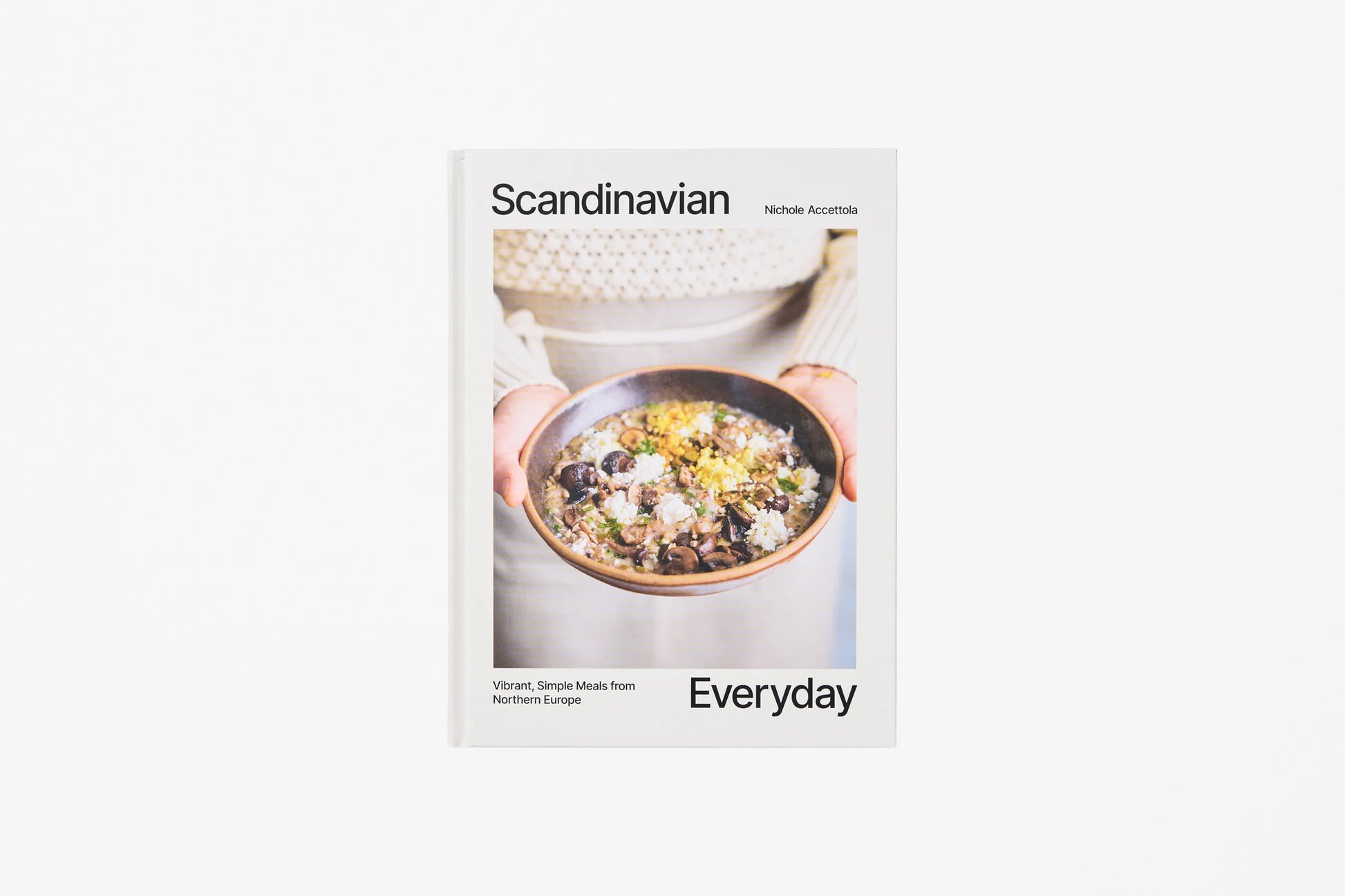 A cookbook titled 'Scandinavian Everyday' featuring a cover with a photograph of a bowl of food held by hands, set against a light white background.