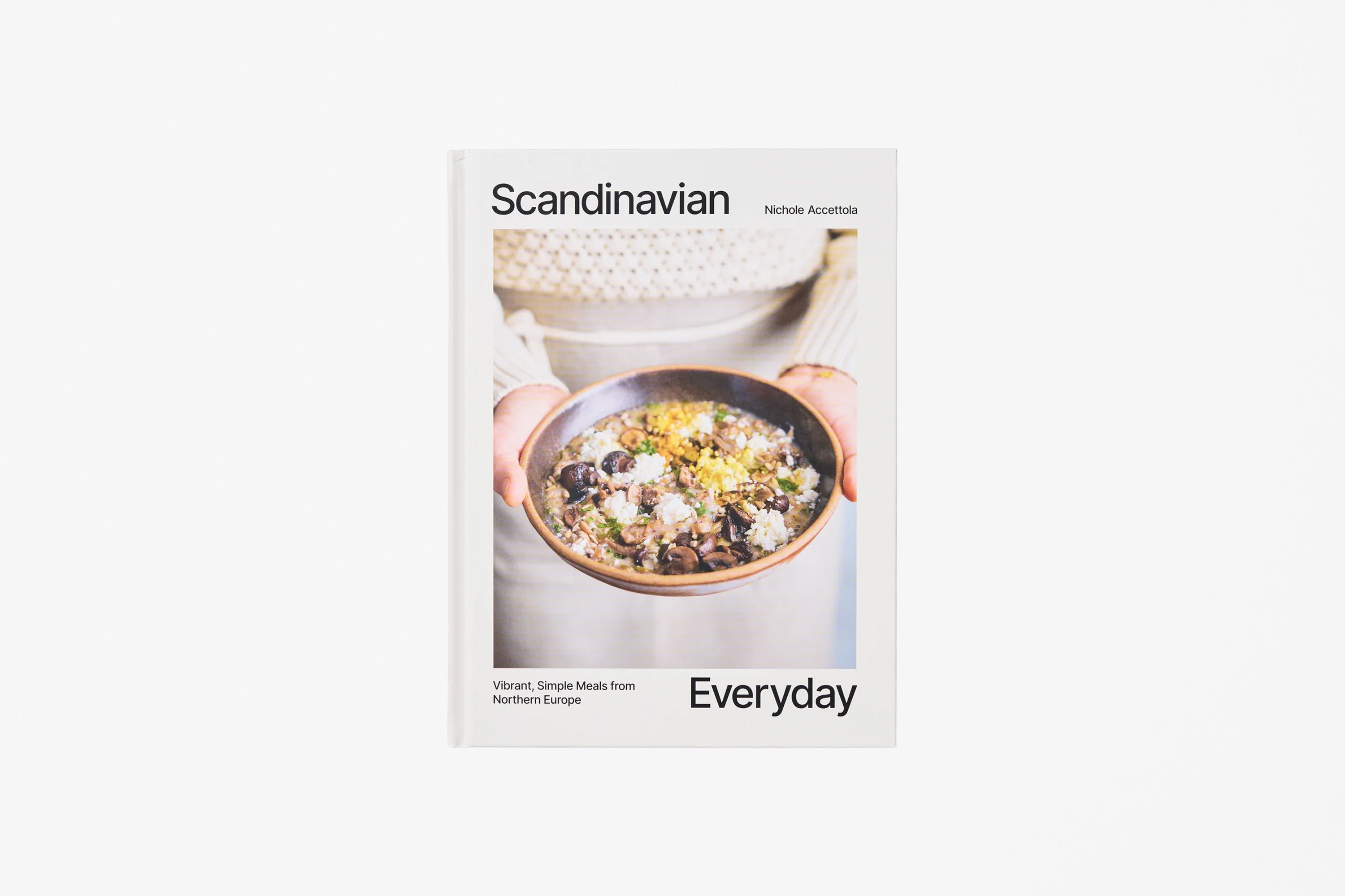 A cookbook titled 'Scandinavian Everyday' featuring a cover with a photograph of a bowl of food held by hands, set against a light white background.